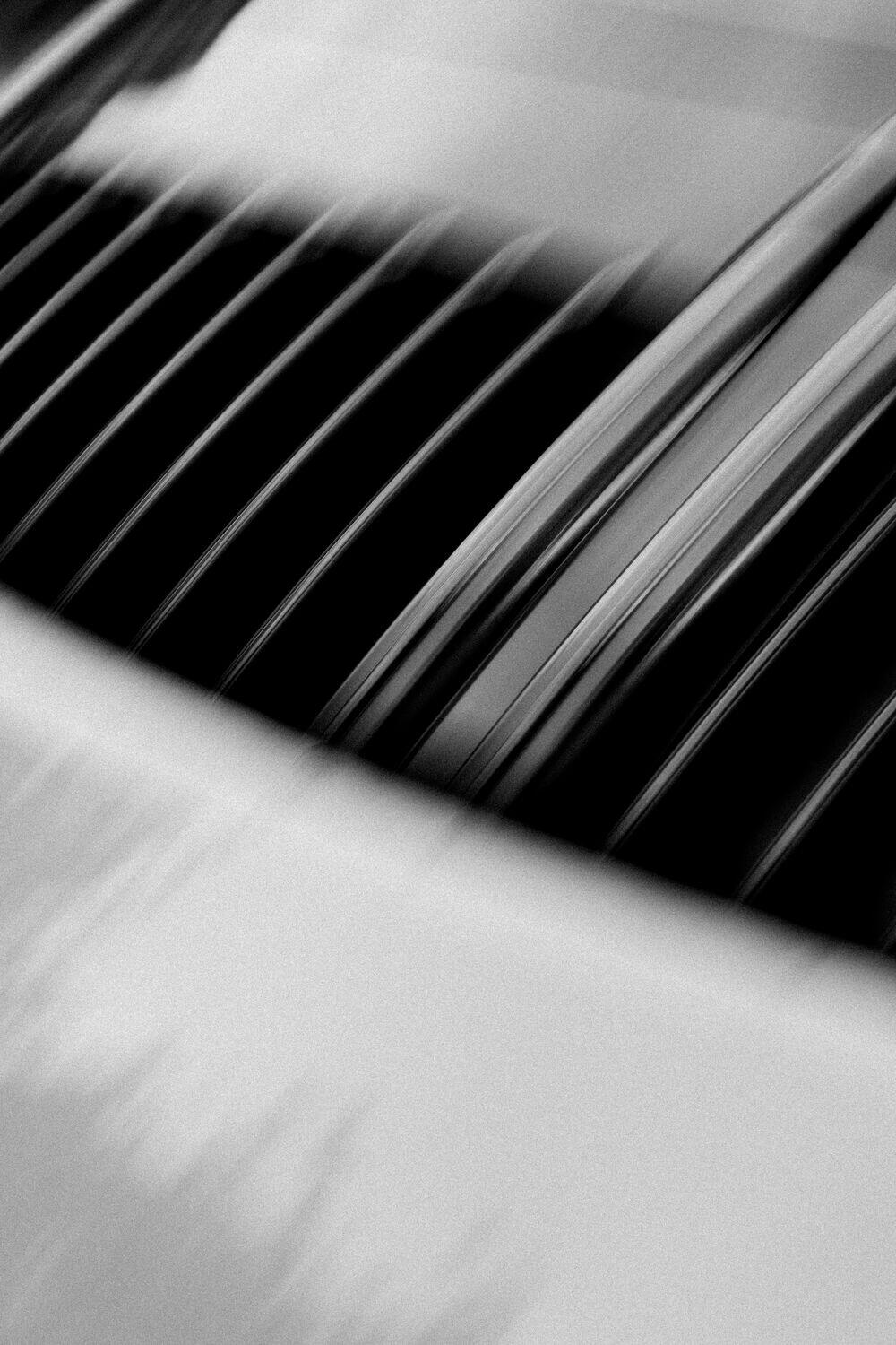 Dark architectural lines, motion-blurred into ordered streaks
