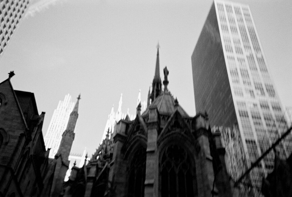 A cathedral and modern towers against the sky