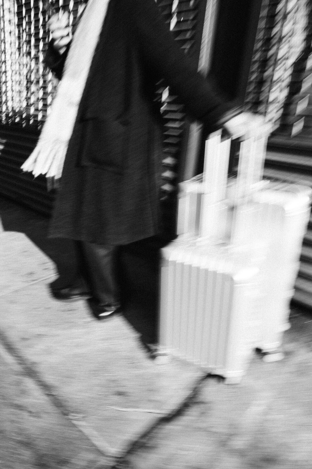 A traveler with a suitcase on a city street
