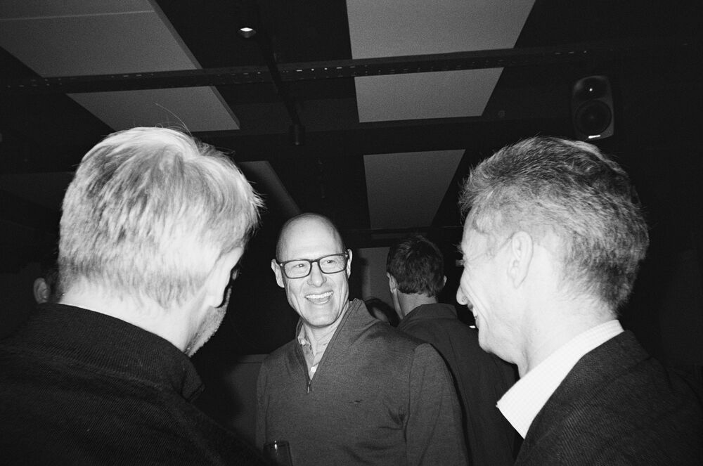Two partners laughing together at an evening event