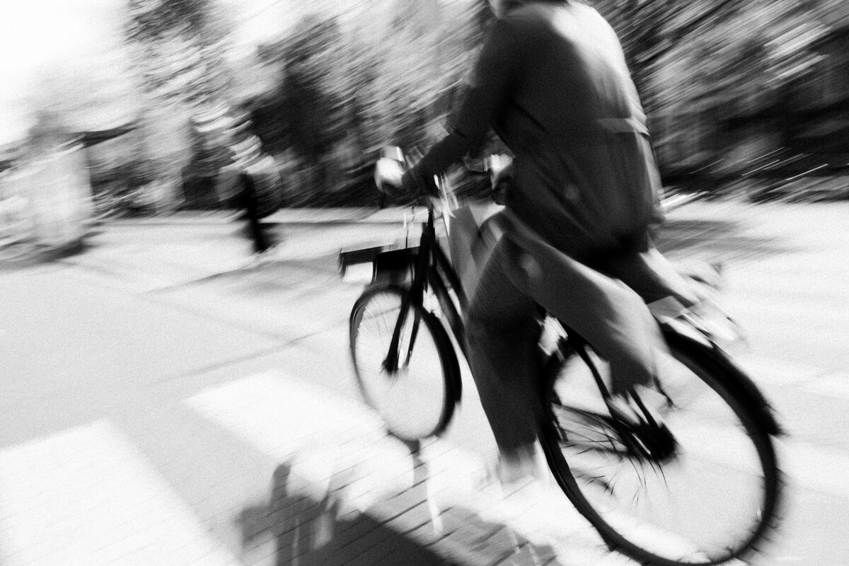 A cyclist in motion on a city street, blurred